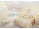 Relaxing bedroom with a ceiling fan, decorative artwork, and sunny window at 20631 Prince Ranier Pl, Leesburg, FL 34748