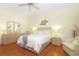 Serene bedroom with light wood furniture, ceiling fan, and ample closet space at 20631 Prince Ranier Pl, Leesburg, FL 34748