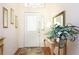 Inviting foyer with hardwood floors, decorative mirror, and elegant decor at 20631 Prince Ranier Pl, Leesburg, FL 34748