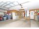 Functional garage with storage, pegboards and overhead lighting at 20631 Prince Ranier Pl, Leesburg, FL 34748