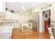 Bright kitchen with stainless steel appliances, island, and light colored cabinets at 20631 Prince Ranier Pl, Leesburg, FL 34748