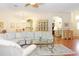 Spacious living room showcasing hardwood floors and open-concept design with archways at 20631 Prince Ranier Pl, Leesburg, FL 34748