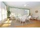 Bright sunroom featuring white wicker furniture, a ceiling fan, and lots of natural light at 20631 Prince Ranier Pl, Leesburg, FL 34748