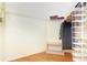 Spacious walk-in closet with shelving, wooden floors and hanging storage at 20631 Prince Ranier Pl, Leesburg, FL 34748