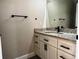 Modern bathroom with a granite-topped vanity, sleek black fixtures, and ample storage at 217 S East St, Leesburg, FL 34748