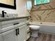 Bathroom featuring white vanity, tub, shower, toilet, and wood-look tiled flooring at 217 S East St, Leesburg, FL 34748