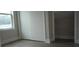 Well-lit bedroom with a large closet and a window with natural light at 217 S East St, Leesburg, FL 34748