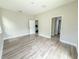 Spacious bedroom showcasing a view into kitchen and hallway through open doorways at 217 S East St, Leesburg, FL 34748