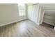 Bedroom featuring a closet, a window, and wood look flooring at 217 S East St, Leesburg, FL 34748