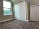 Cozy bedroom features plush carpeting, a bright window, and ample closet space at 217 S East St, Leesburg, FL 34748