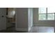Bedroom featuring wood-look vinyl floors, closet, and an attached bathroom at 217 S East St, Leesburg, FL 34748