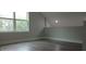 A bonus room with vinyl floors and a large double window with natural light at 217 S East St, Leesburg, FL 34748