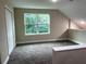 Spacious bonus room with large window and neutral carpeting, perfect for flexible living at 217 S East St, Leesburg, FL 34748