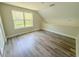Bright bonus room features luxury vinyl plank flooring and a large window for natural light and outdoor views at 217 S East St, Leesburg, FL 34748