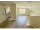 Spacious bonus room with luxury vinyl plank flooring and ample natural light, perfect for various activities at 217 S East St, Leesburg, FL 34748