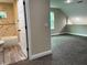 Bonus room connecting to a bathroom features neutral carpet and a window at 217 S East St, Leesburg, FL 34748