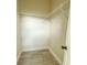 Empty walk-in closet with white wire shelving, tile floors, and white trim, offering ample storage space at 217 S East St, Leesburg, FL 34748