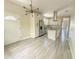 Modern kitchen featuring white cabinets, stainless steel appliances, granite countertops, and stylish lighting fixture at 217 S East St, Leesburg, FL 34748