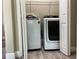 Bright laundry room features a modern washer and dryer set with convenient overhead shelving at 217 S East St, Leesburg, FL 34748