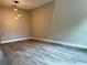 Spacious living room with sleek wood-look flooring and modern lighting fixtures at 217 S East St, Leesburg, FL 34748
