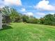 Spacious backyard with screened lanai offers a serene outdoor retreat and adds property value at 2259 Lockwood Loop, The Villages, FL 32162