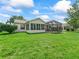 The home has a spacious backyard featuring a screened-in lanai and ample green space at 2259 Lockwood Loop, The Villages, FL 32162