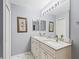 Bathroom featuring double sinks, granite countertops and ample lighting at 2259 Lockwood Loop, The Villages, FL 32162