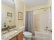 Well-lit bathroom featuring a shower-tub combination and a granite countertop vanity at 2259 Lockwood Loop, The Villages, FL 32162