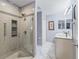 Bright bathroom featuring a tiled glass shower and double sink vanity at 2259 Lockwood Loop, The Villages, FL 32162