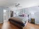 Bright bedroom featuring a ceiling fan, wood floors, and ensuite bathroom and closet at 2259 Lockwood Loop, The Villages, FL 32162