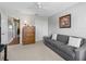 Comfortable bedroom with plush carpet, a gray couch, and a spacious closet for ample storage at 2259 Lockwood Loop, The Villages, FL 32162