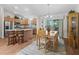 Open concept dining room adjacent to an island kitchen with granite countertops and stainless steel appliances at 2259 Lockwood Loop, The Villages, FL 32162