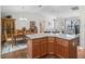 Open-concept kitchen and dining area featuring a kitchen island with granite countertop at 2259 Lockwood Loop, The Villages, FL 32162