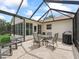 Screened patio area with outdoor dining furniture, perfect for enjoying al fresco meals at 2259 Lockwood Loop, The Villages, FL 32162