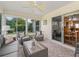 Inviting sunroom with lots of windows, tile floors and seating, ideal for relaxing and entertaining at 2259 Lockwood Loop, The Villages, FL 32162