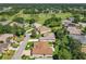 An aerial view of a home surrounded by a golf course and green trees in a beautiful neighborhood at 24436 Madewood Ave, Leesburg, FL 34748
