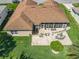 Aerial view of property with a large patio and lush, green lawn at 24436 Madewood Ave, Leesburg, FL 34748