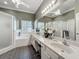 Primary bathroom with large double vanity, soaking tub, and walk-in shower at 24436 Madewood Ave, Leesburg, FL 34748