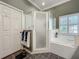 Ensuite bathroom featuring a soaking tub, stand up shower and neutral finishes at 24436 Madewood Ave, Leesburg, FL 34748