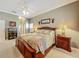 Primary bedroom featuring ensuite bath and plantation shutters at 24436 Madewood Ave, Leesburg, FL 34748