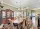 Elegant dining room featuring a chandelier, hardwood floors, and a decorative area rug at 24436 Madewood Ave, Leesburg, FL 34748
