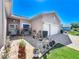 Attractive home with brick-paved driveway and walkway, enhanced by potted plants and manicured lawn at 24436 Madewood Ave, Leesburg, FL 34748