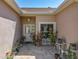Welcoming front porch with decorative plants, a seating area, and a brick-paved surface at 24436 Madewood Ave, Leesburg, FL 34748