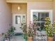 Covered front porch with potted plants and a decorative table with chairs by the front door at 24436 Madewood Ave, Leesburg, FL 34748