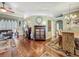 Open-concept great room showcasing hardwood floors, stylish decor, and ample living space at 24436 Madewood Ave, Leesburg, FL 34748