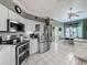 Well-lit kitchen with stainless steel appliances, granite countertops and white cabinets at 24436 Madewood Ave, Leesburg, FL 34748