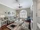 Cozy living room featuring hardwood floors, neutral paint, and a large window at 24436 Madewood Ave, Leesburg, FL 34748