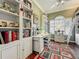 Bright office featuring custom built-in bookshelves, desk and decorative rug at 24436 Madewood Ave, Leesburg, FL 34748