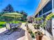 Open patio with ample seating featuring brick pavers and a green umbrella at 24436 Madewood Ave, Leesburg, FL 34748