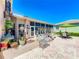 Enjoy this open patio with brick pavers, a seating area, and potted plants at 24436 Madewood Ave, Leesburg, FL 34748